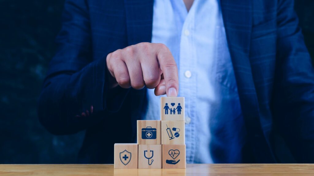 Health Insurance and medical care concept, wooden blocks displaying health related icons, medical care, health insurance, medication. healthcare services, protection, insurance coverage
